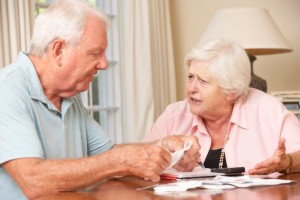 Older couple talking with financial papers in front